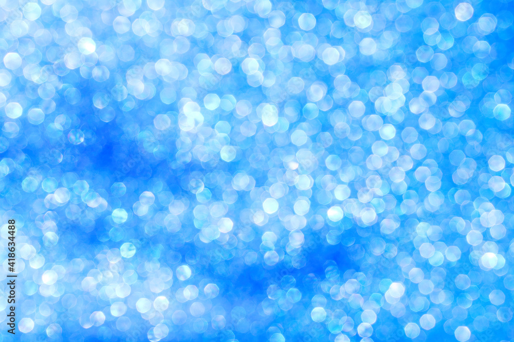 delicate blurry blue bokeh with white glitter close-up