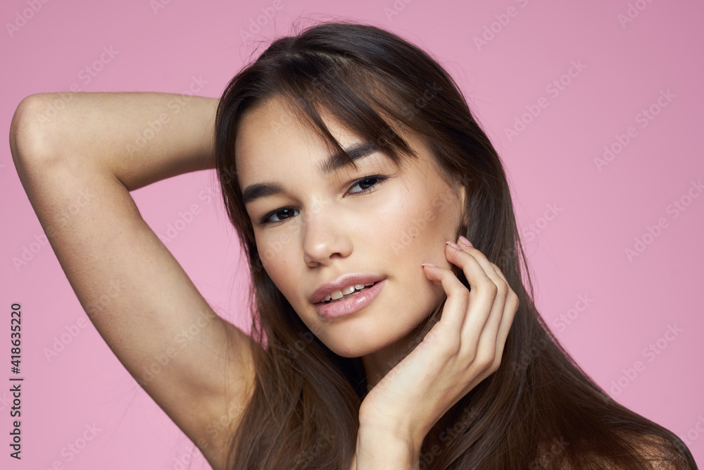 Pretty brunette naked shoulders clear skin pink background Pretty brunette naked shoulders clear skin pink background