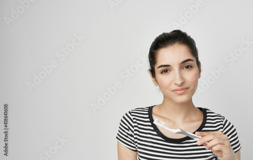 woman in striped t-shirt toothbrush dental health hygiene © SHOTPRIME STUDIO