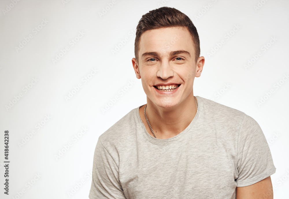 Cheerful handsome man gray t-shirt lifestyle cropped view Cheerful handsome man gray t-shirt lifestyle cropped view