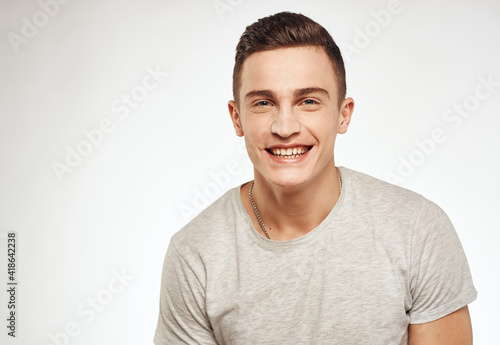 Cheerful handsome man gray t-shirt lifestyle cropped view