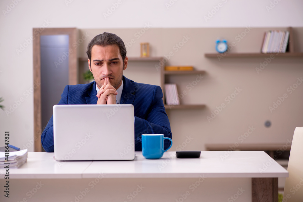 Young male employee working from home in pandemic concept Young male employee working from home in pandemic concept