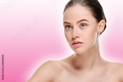 Portrait of attractive smiling girl with clean fresh face on a pink background with a shaded white outline
