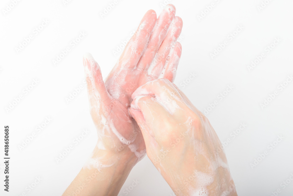 A person washing hands on a white background A person washing hands on a white background