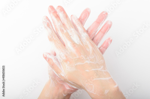 A person washing hands on a white background