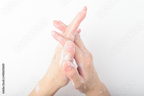 A person washing hands on a white background