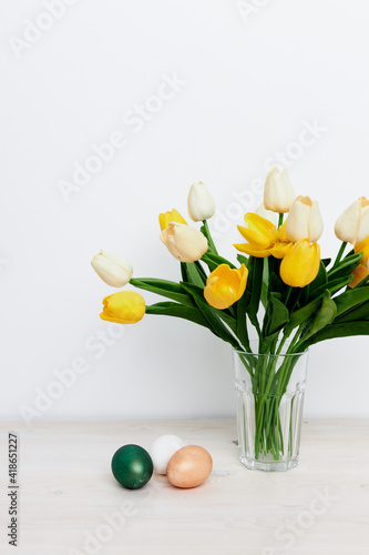 Easter holiday church traditions colorful eggs and yellow tulips