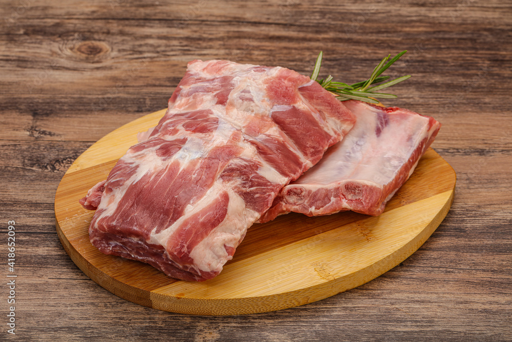 Raw pork ribs served rosemary