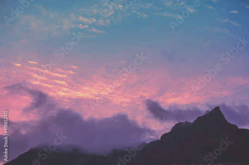 Silhouette of mountains against the purple sunset sky. Norway nature