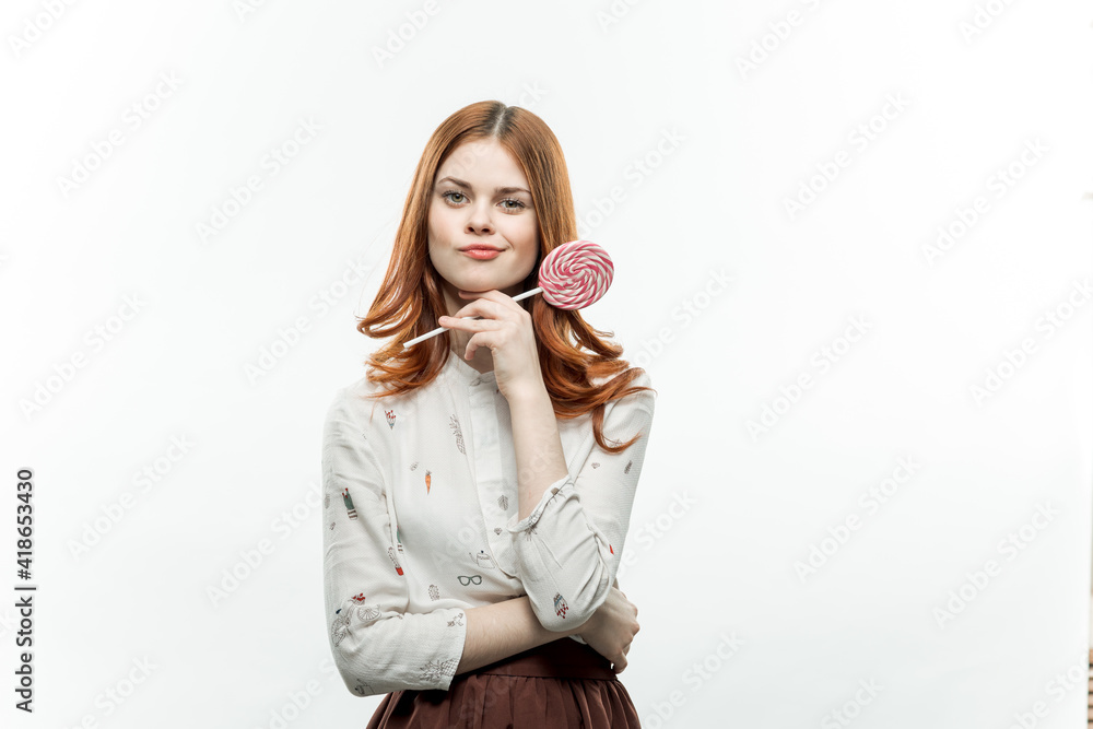 pretty red-haired woman with multicolored lollipops in her hands joy sweets pretty red-haired woman with multicolored lollipops in her hands joy sweets