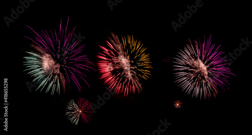 Fireworks with different color and pattern for celebration in various events including new year, party, ceremony, birthday or other show and display on night dark sky background.