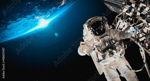 Fototapeta Naklejka Na Ścianę i Meble -  Astronaut spaceman do spacewalk while working for space station in outer space . Astronaut wear full spacesuit for space operation . Elements of this image furnished by NASA space astronaut photos.
