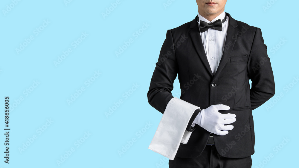 Handsome waiter in tuxedo and gloves holding empty tray and napkin whit Dicut part Handsome waiter in tuxedo and gloves holding empty tray and napkin whit Dicut part