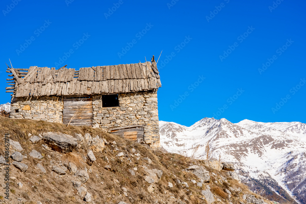 Winter evening landscape in french Alps. Old stone abandoned house on the mountain. Winter evening landscape in french Alps. Old stone abandoned house on the mountain.