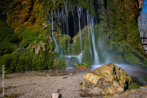 View of the colorful Dreimühlen waterfall in the Eifel