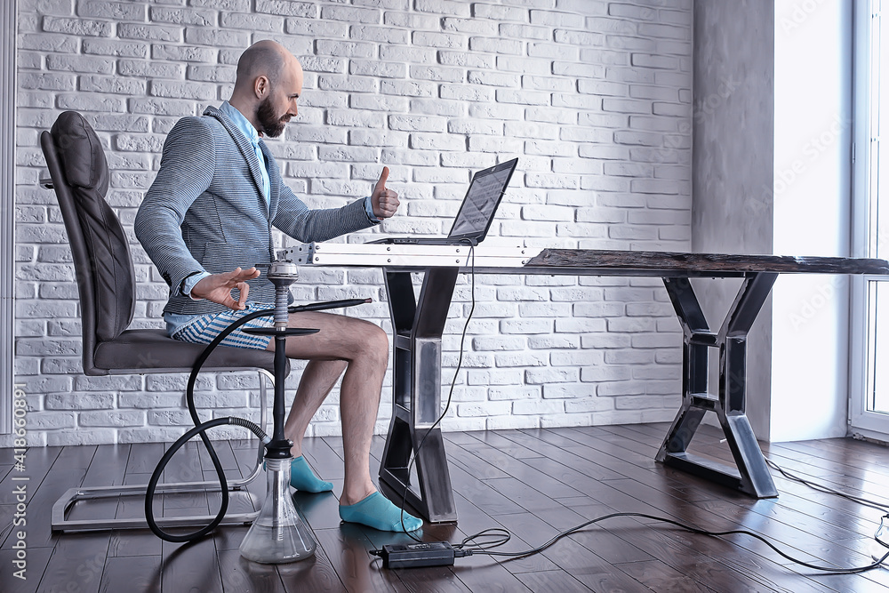 funny man in works at home, smokes a hookah at a remote work, quarantine coronavirus in underpants Stock Photo | Adobe Stock