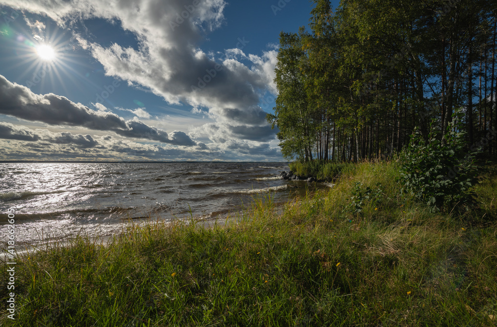 Shore at a large lake in windy conditions and full sun