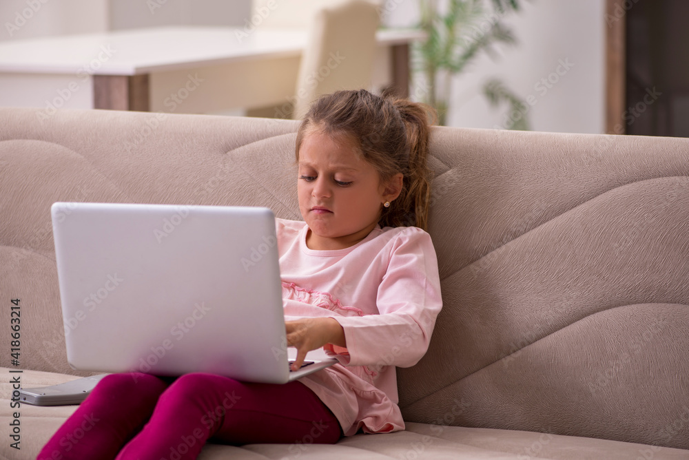 Small girl in tele-education concept at home Small girl in tele-education concept at home