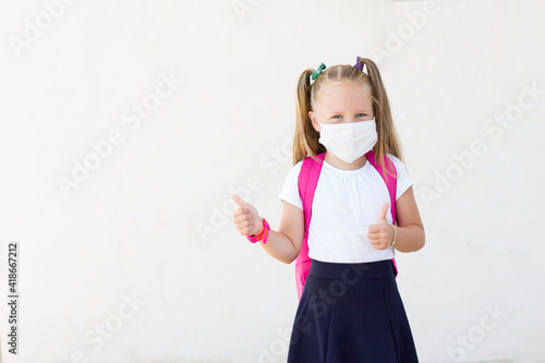 girl with a backpack in a mask.School