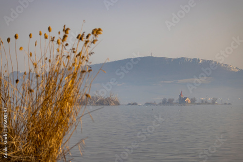 Lake Musov with Church of St. Linhart in Musov, Southern Bohemia, Czech Republic photo