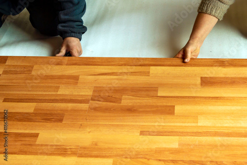 Installing laminate flooring in a room.
