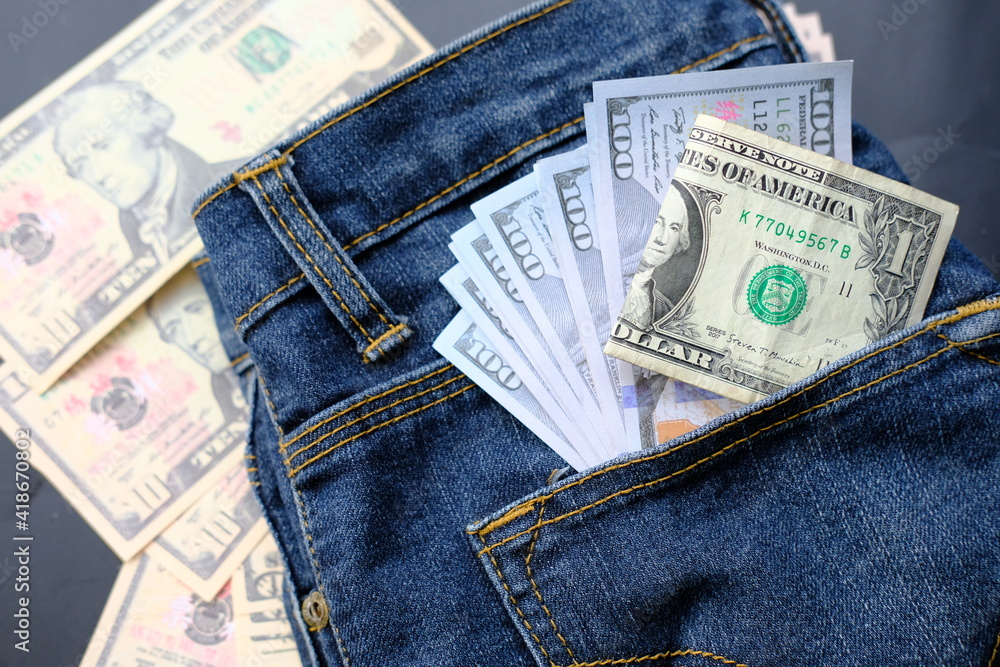 Banknote money in pocket jeans and saving money and business growth concept,finance and investment concept Banknote money in pocket jeans and saving money and business growth concept,finance and investment concept