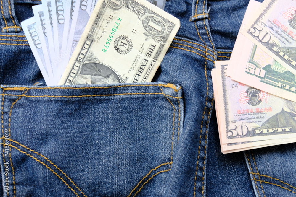Banknote money in pocket jeans and saving money and business growth concept,finance and investment concept Banknote money in pocket jeans and saving money and business growth concept,finance and investment concept