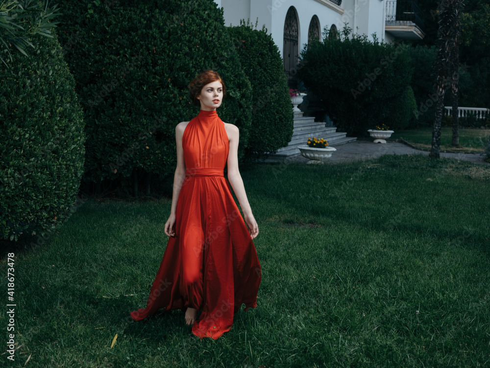 Pretty woman red dress walking luxury model outdoors