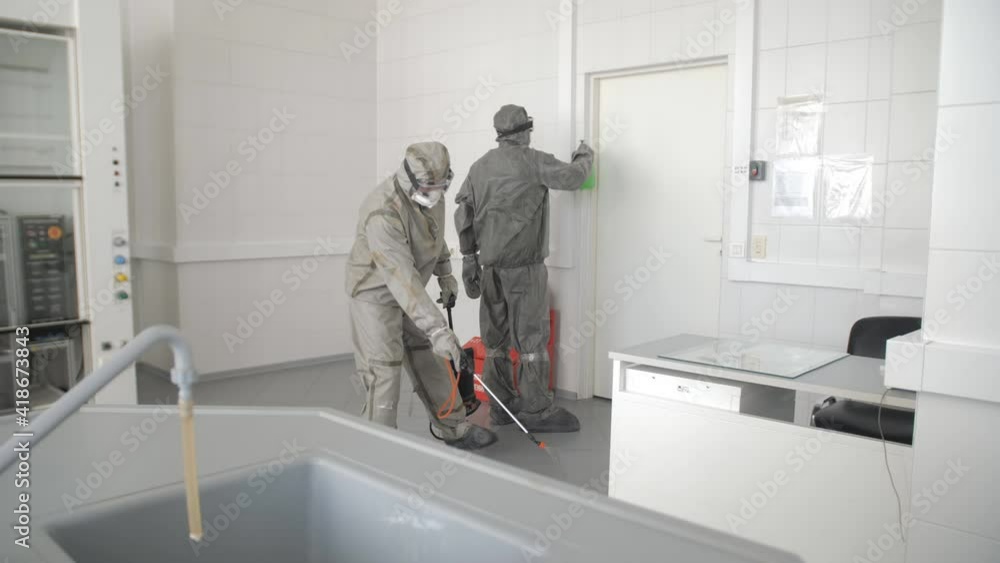 Home disinfection by commercial disinfecting services. Frontline Coronavirus Worker in Hazmat Suit Disinfecting from COVID-19 Home disinfection by commercial disinfecting services. Frontline Coronavirus Worker in Hazmat Suit Disinfecting from COVID-19