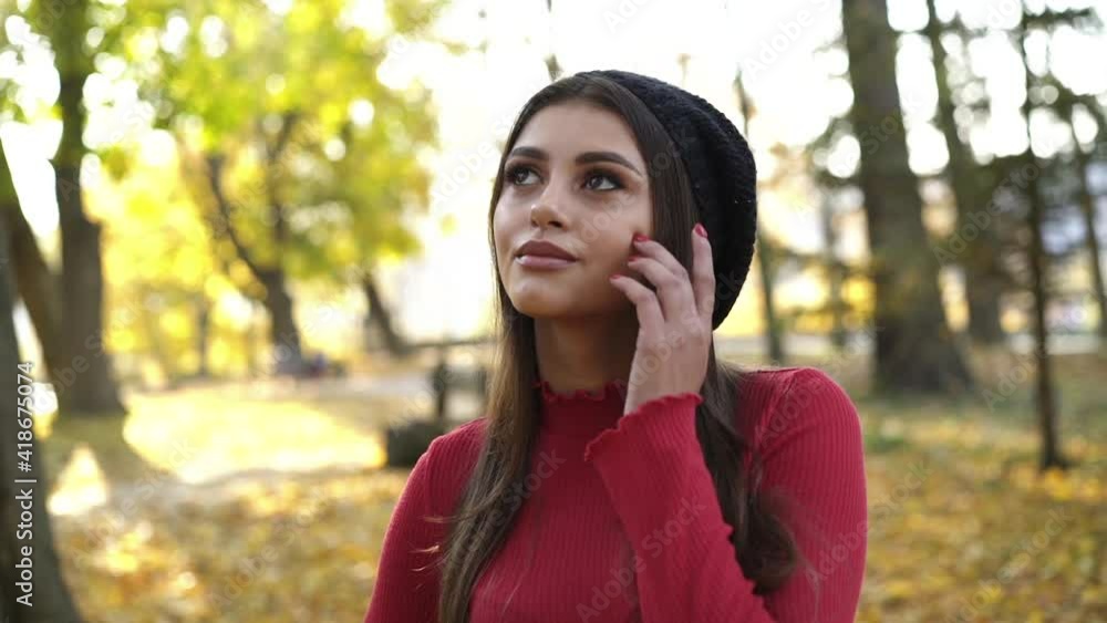Happy brunette looking around with joy and smiling at camera in autumn park Happy brunette looking around with joy and smiling at camera in autumn park