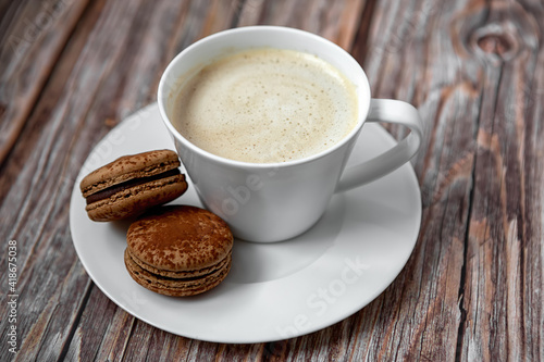 A cup of coffee with dessert on a white plate