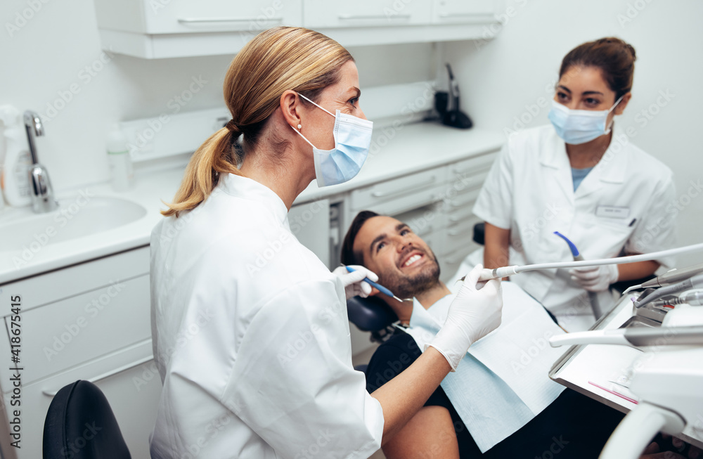 Dental doctor treating patient in clinic Dental doctor treating patient in clinic
