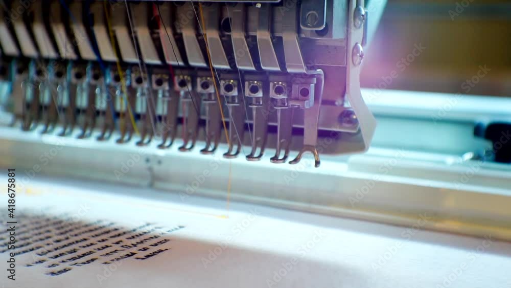 working industrial embroidery machine.Piece of equipment. Close-up. working industrial embroidery machine.Piece of equipment. Close-up.