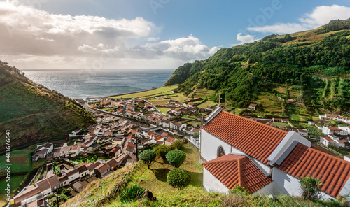 Small village Faial da Terra between rolling hills in warm afternoon light on Sao Miguel Island in the Azores