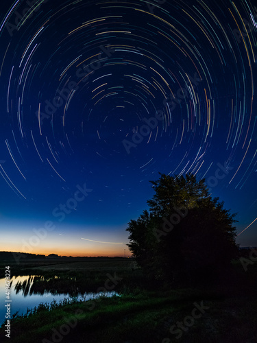 Star trails over a lake in the night