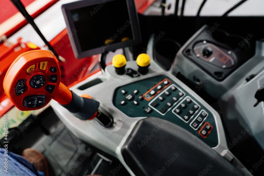 focus on joystick.Multifunctional lever in control cabin of agricultural combine