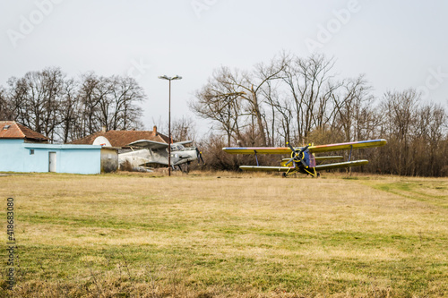 Novi Sad, Serbia - March 05. 2021: Two aircraft parked - Antonov (PZL-Mielec) An-2R, off the runway at the Aero Club Novi Sad, Serbia. 