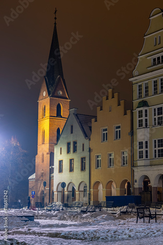 Olsztyn Old Town in winter at night - tenement houses in the Old Town and the Evangelical Church
