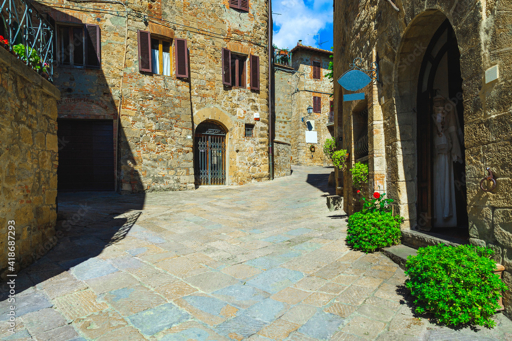 Cozy street and entrances decorated with green plants, Tuscany, Italy