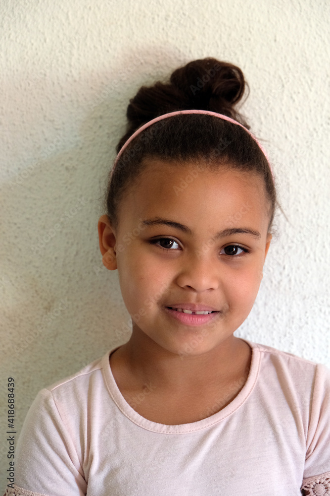 Cute girl daughter with top bun expression small sile Cute girl daughter with top bun expression small sile