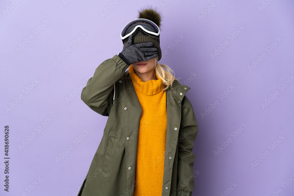 Skier Russian girl with snowboarding glasses isolated on purple background covering eyes by hands. Do not want to see something Skier Russian girl with snowboarding glasses isolated on purple background covering eyes by hands. Do not want to see something