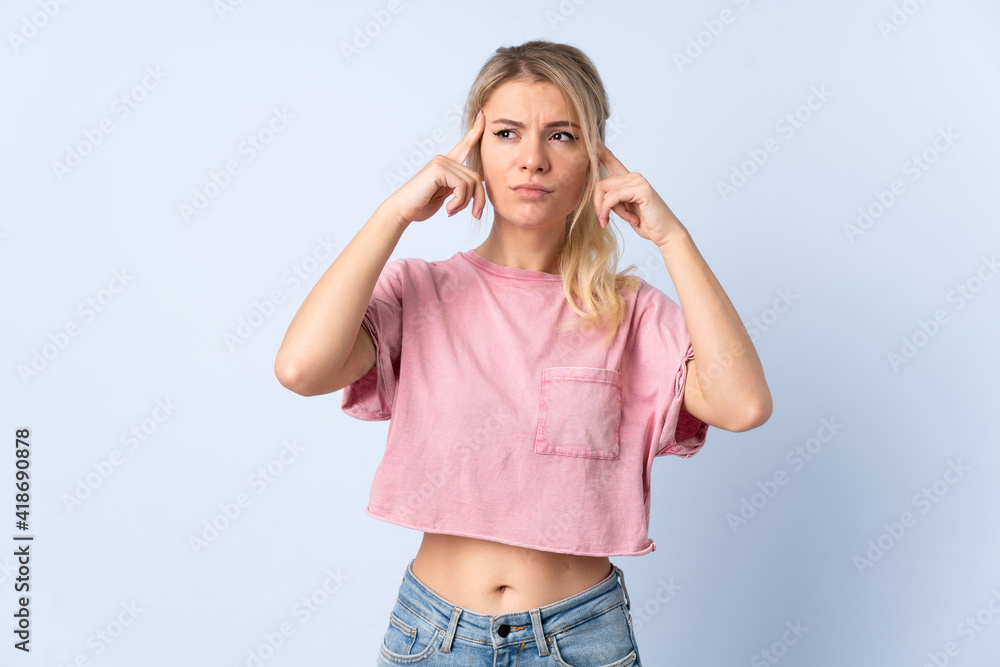 Blonde woman over isolated blue background having doubts and thinking Blonde woman over isolated blue background having doubts and thinking