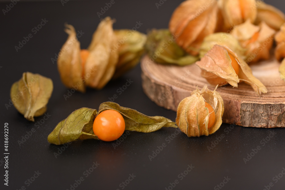 Ripe berry physalis on the wooden board. Ripe berry physalis on the wooden board.