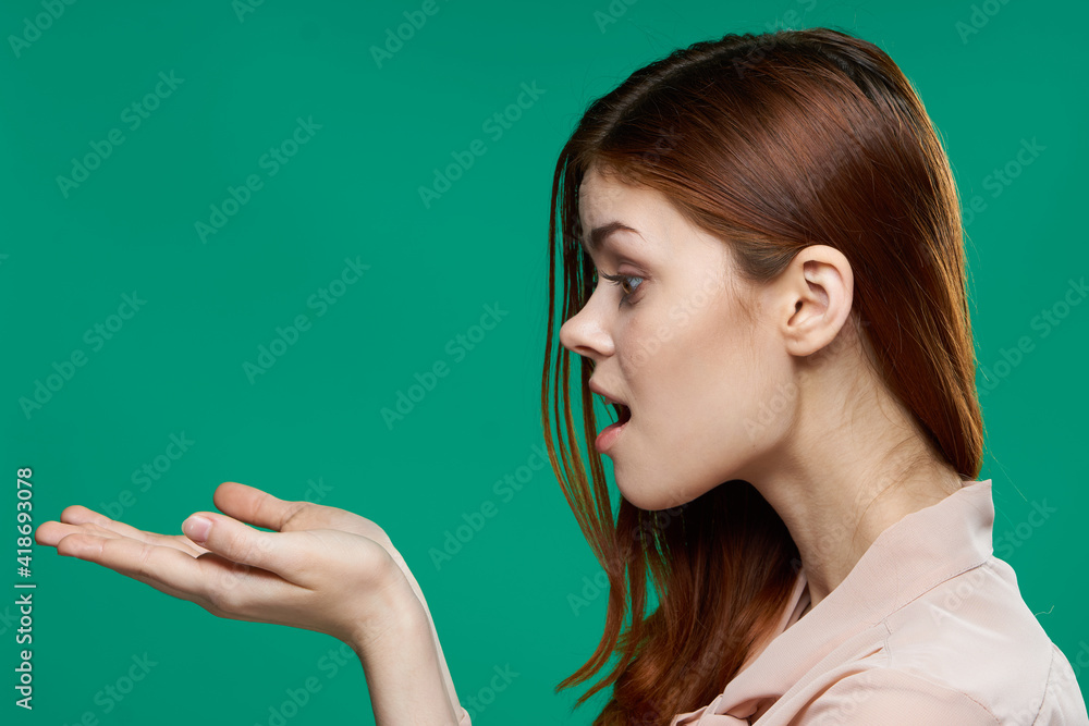 surprised woman holding palms in front of her emotions side view close-up green background surprised woman holding palms in front of her emotions side view close-up green background