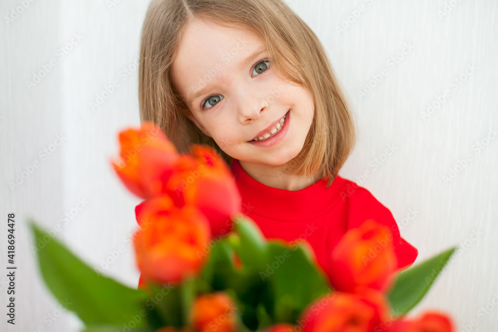 Beautiful girl in a bright red turtleneck holding a bouquet of red tulips. High quality photo Beautiful girl in a bright red turtleneck holding a bouquet of red tulips. High quality photo