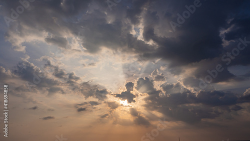 Stunning skyscape background. cloudy evening with the beautiful color of sunlight, sunbeams, rays shines through heavenly clouds. aerial view cloudscapes. nature landscape background © phoomrat