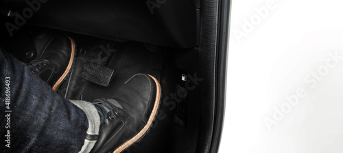 Accelerator and breaking pedal in a car. Close up the foot pressing foot pedal of a car to drive ahead. Driver driving the car by pushing accelerator pedals of the car. inside vehicle. 