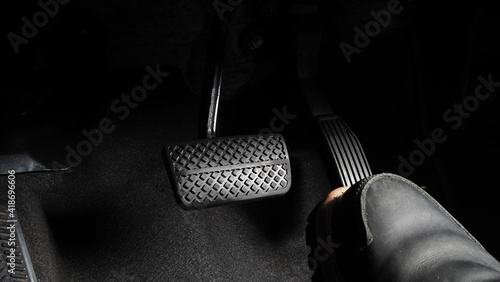 Accelerator and breaking pedal in a car. Close up the foot pressing foot pedal of a car to drive ahead. Driver driving the car by pushing accelerator pedals of the car. inside vehicle. 
