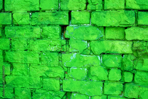 The texture of an old green brick wall. Close-up, pattern.