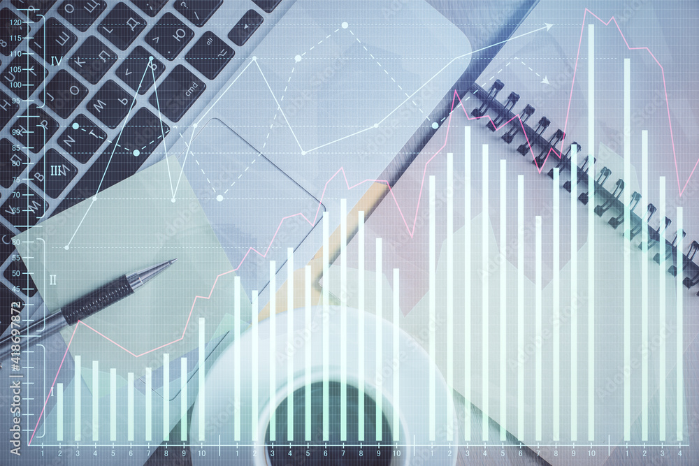 Stock market graph and top view computer on the table background. Double exposure. Concept of financial education. Stock market graph and top view computer on the table background. Double exposure. Concept of financial education.
